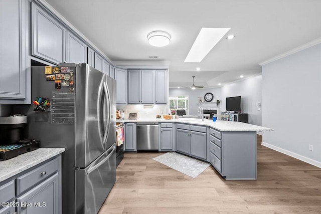 4465 Orchard Knob Ln, High Point, NC 27265 - kitchen featuring stainless steel appliances, a peninsula, crown molding, gray cabinets, and open floor plan