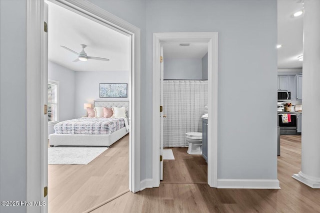 4465 Orchard Knob Ln, High Point, NC 27265 - bedroom with wood finished floors, tile walls, and connected bathroom