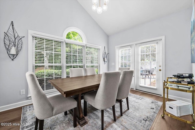 4465 Orchard Knob Ln, High Point, NC 27265 - dining area with healthy amount of natural light, high vaulted ceiling, a chandelier, and wood finished floors