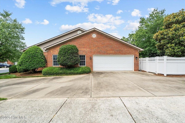 4465 Orchard Knob Ln, High Point, NC 27265 - view of side of home featuring brick siding, driveway, and a garage