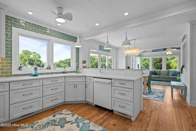 210 Upchurch Dr, Newport, NC 28570 - kitchen featuring white dishwasher, ceiling fan, light countertops, open floor plan, and light wood-type flooring