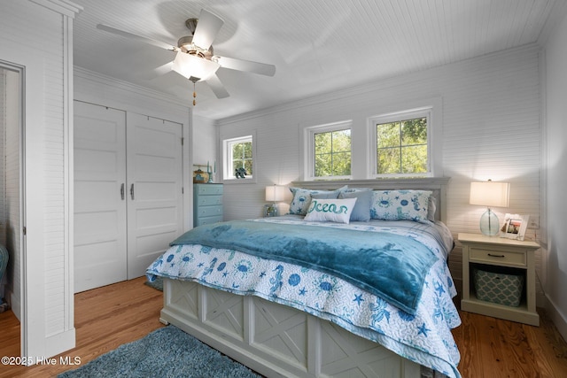 210 Upchurch Dr, Newport, NC 28570 - bedroom with wood finished floors, ornamental molding, a closet, and a ceiling fan