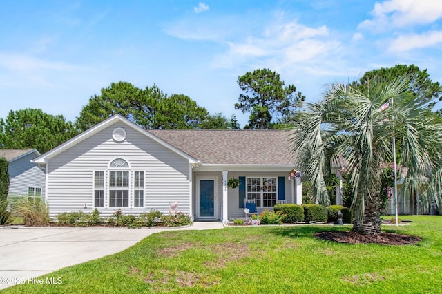 4399 Owendon Dr, Shallotte, NC 28470 - ranch-style home with a front yard and a shingled roof