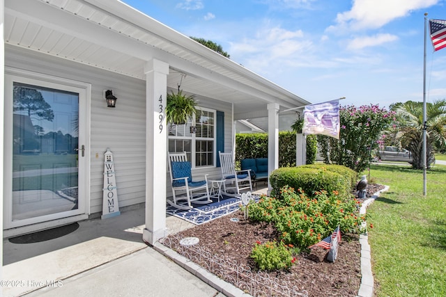4399 Owendon Dr, Shallotte, NC 28470 - doorway to property with covered porch and a lawn