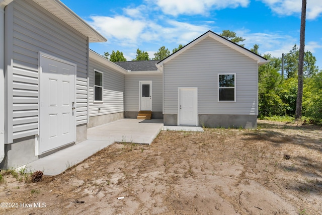 1990 Salisbury Rd, Southport, NC 28461 - back of property featuring a patio and a shingled roof