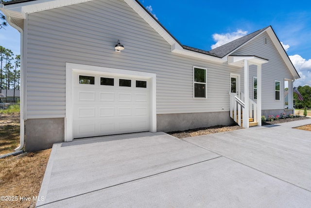 1990 Salisbury Rd, Southport, NC 28461 - view of home's exterior with concrete driveway, an attached garage, entry steps, and roof with shingles