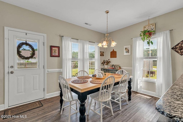 103 Baymeade Ct, Peletier, NC 28584 - dining space featuring dark wood-style flooring, healthy amount of natural light, and a chandelier