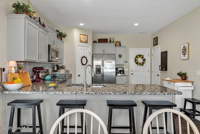 103 Baymeade Ct, Peletier, NC 28584 - kitchen featuring stainless steel appliances, a peninsula, backsplash, light stone countertops, and recessed lighting