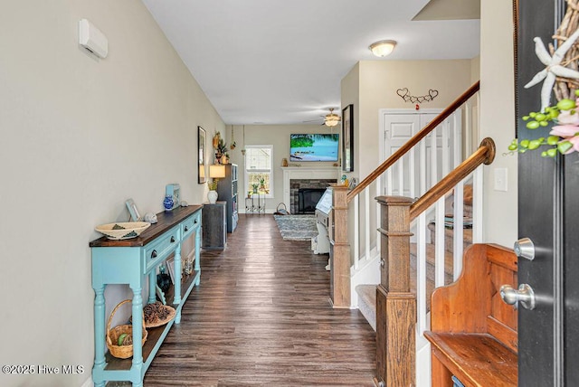 103 Baymeade Ct, Peletier, NC 28584 - entrance foyer with dark wood-type flooring, stairs, a stone fireplace, and ceiling fan