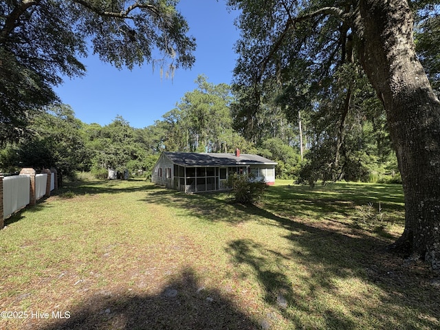 1677 Gause Landing Rd SW, Ocean Isle Beach, NC 28469 - view of yard featuring a sunroom and a forest view