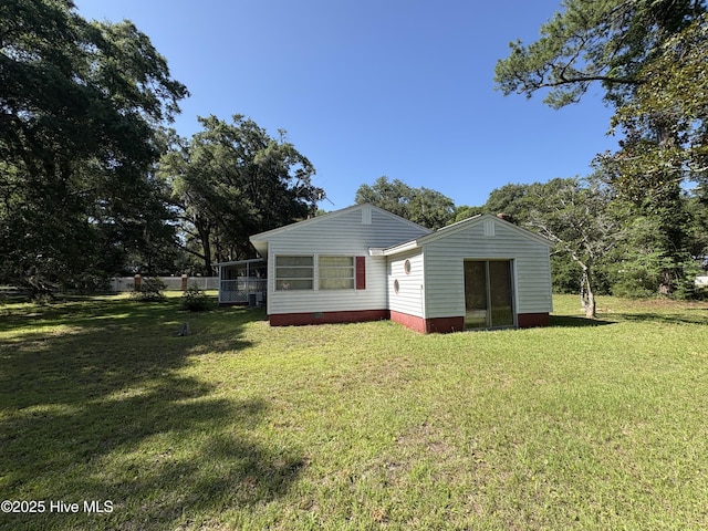1677 Gause Landing Rd SW, Ocean Isle Beach, NC 28469 - back of house featuring a lawn and a sunroom