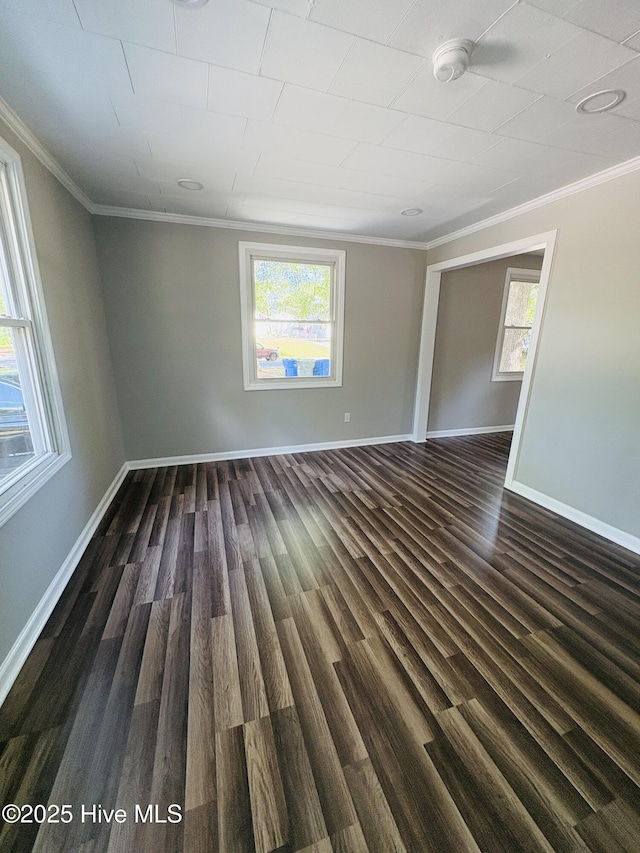 1209 Toisnot Ave NE, Wilson, NC 27893 - unfurnished room featuring crown molding, a smoke detector, and dark wood-type flooring