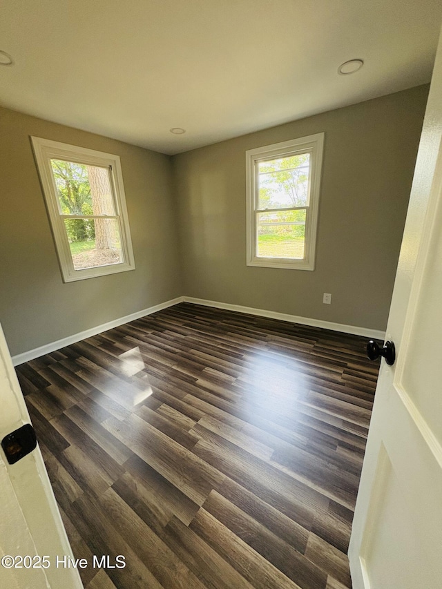 1209 Toisnot Ave NE, Wilson, NC 27893 - empty room featuring healthy amount of natural light, dark wood finished floors, and recessed lighting