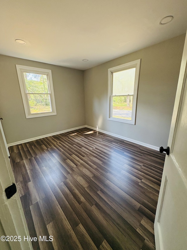 1209 Toisnot Ave NE, Wilson, NC 27893 - spare room featuring dark wood-style flooring and recessed lighting