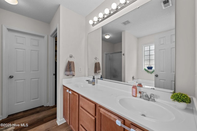 2950 Judge Manly Dr, New Bern, NC 28562 - full bath featuring a shower stall, double vanity, wood finished floors, a garden tub, and a textured ceiling