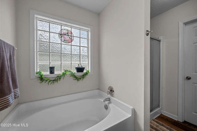 2950 Judge Manly Dr, New Bern, NC 28562 - bathroom featuring a bath, wood finished floors, and a stall shower