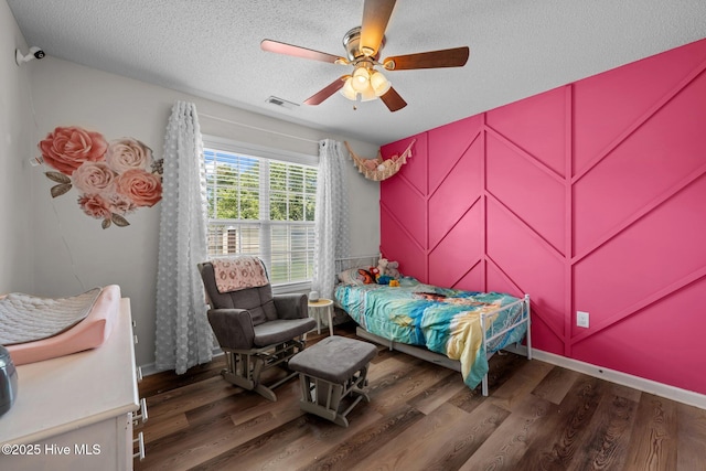 2950 Judge Manly Dr, New Bern, NC 28562 - bedroom featuring wood finished floors, a textured ceiling, and a ceiling fan