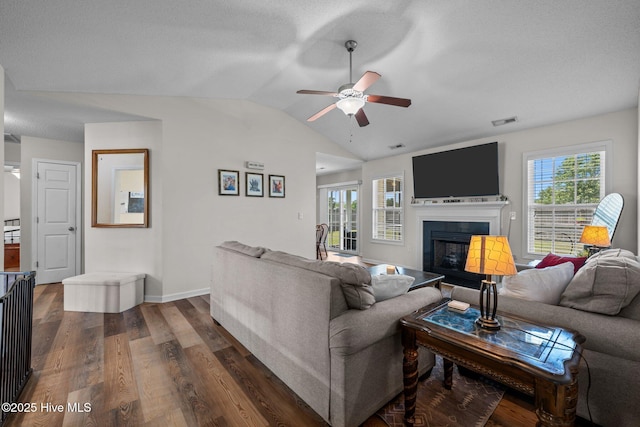 2950 Judge Manly Dr, New Bern, NC 28562 - living room with a ceiling fan, lofted ceiling, dark wood-style flooring, a fireplace, and a textured ceiling