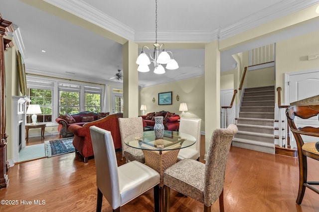 90 Shadow Creek Ct, Pinehurst, NC 28374 - dining room featuring crown molding, wood finished floors, stairway, a chandelier, and a ceiling fan