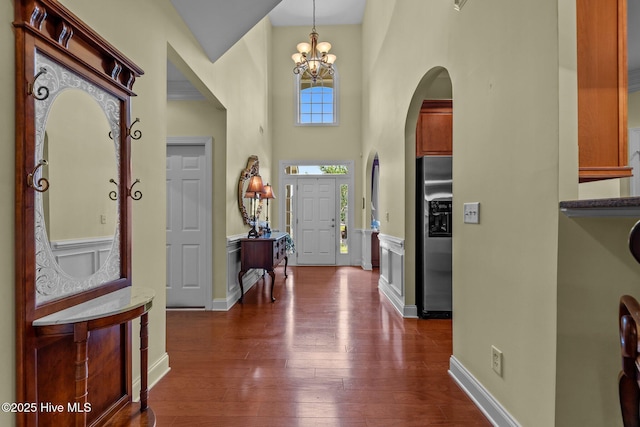 90 Shadow Creek Ct, Pinehurst, NC 28374 - entrance foyer featuring a towering ceiling, dark wood finished floors, a chandelier, and arched walkways