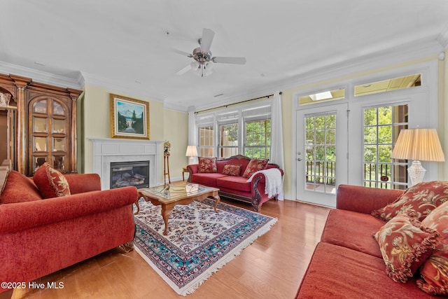 90 Shadow Creek Ct, Pinehurst, NC 28374 - living room with crown molding, a ceiling fan, a glass covered fireplace, and wood finished floors