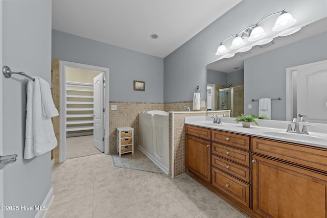 90 Shadow Creek Ct, Pinehurst, NC 28374 - bathroom featuring a stall shower, double vanity, tile patterned flooring, a bath, and tile walls