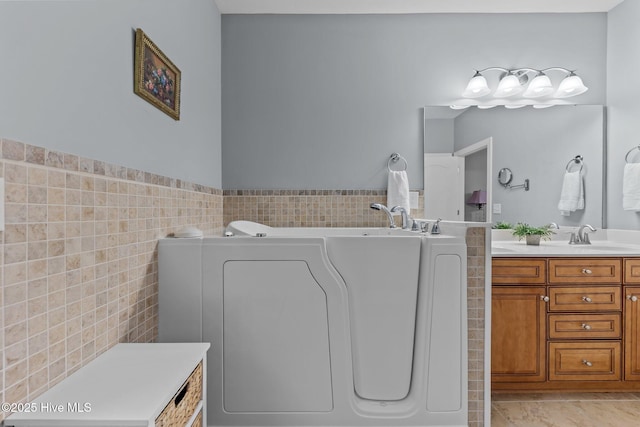 90 Shadow Creek Ct, Pinehurst, NC 28374 - full bathroom with tile walls, vanity, a garden tub, washer / dryer, and tile patterned flooring