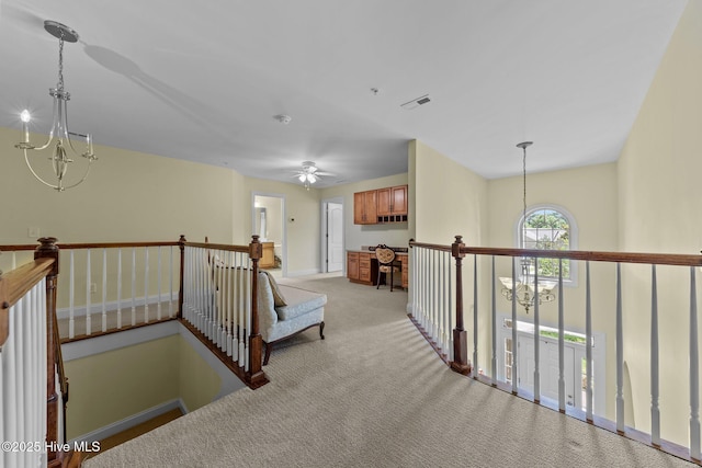 90 Shadow Creek Ct, Pinehurst, NC 28374 - hall featuring a chandelier, light colored carpet, and an upstairs landing