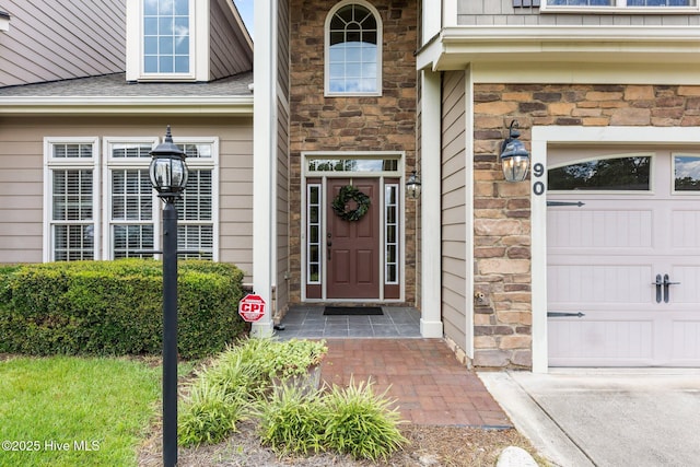 90 Shadow Creek Ct, Pinehurst, NC 28374 - view of exterior entry with stone siding, driveway, and a shingled roof