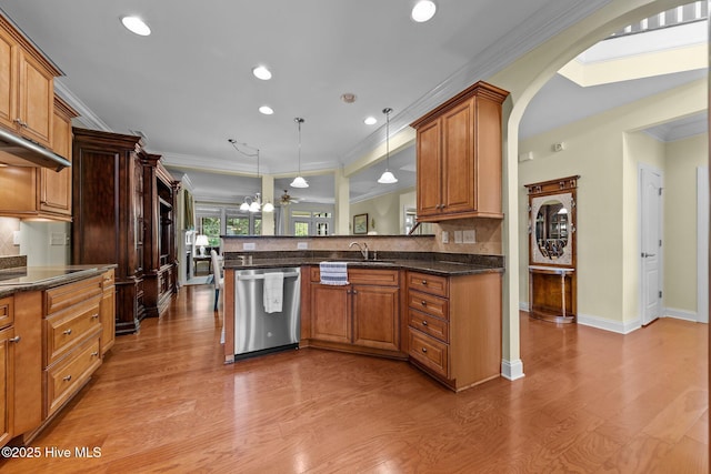 90 Shadow Creek Ct, Pinehurst, NC 28374 - kitchen with dishwasher, arched walkways, wood finished floors, a peninsula, and crown molding