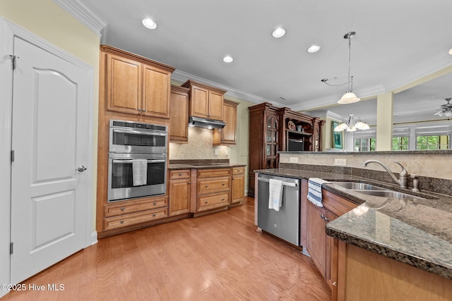 90 Shadow Creek Ct, Pinehurst, NC 28374 - kitchen featuring stainless steel appliances, ornamental molding, under cabinet range hood, backsplash, and hanging light fixtures