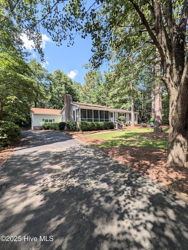 106 Brown Bark Rd, West End, NC 27376 - ranch-style home with a sunroom, driveway, and a chimney