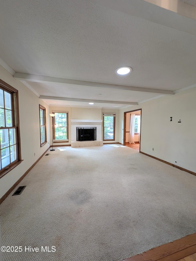 106 Brown Bark Rd, West End, NC 27376 - unfurnished living room with carpet, a textured ceiling, a glass covered fireplace, beam ceiling, and recessed lighting