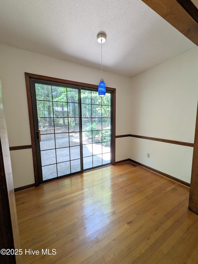 106 Brown Bark Rd, West End, NC 27376 - empty room featuring light wood-type flooring and a textured ceiling