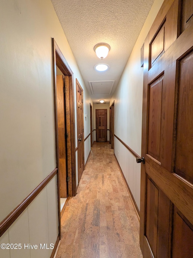 106 Brown Bark Rd, West End, NC 27376 - hallway featuring attic access and a textured ceiling