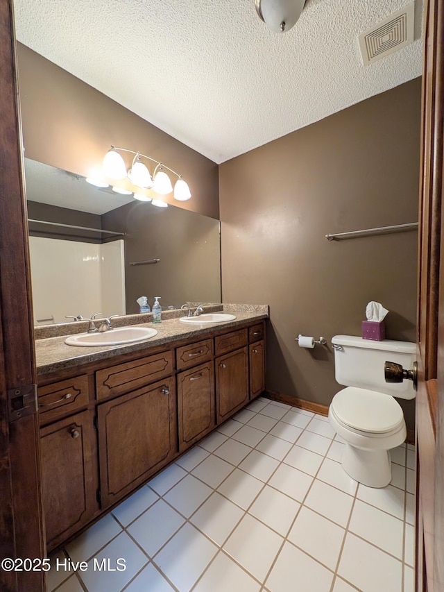 106 Brown Bark Rd, West End, NC 27376 - bathroom featuring double vanity, tile patterned flooring, and a textured ceiling