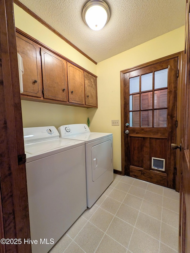 106 Brown Bark Rd, West End, NC 27376 - laundry room with washer and clothes dryer, cabinet space, and a textured ceiling