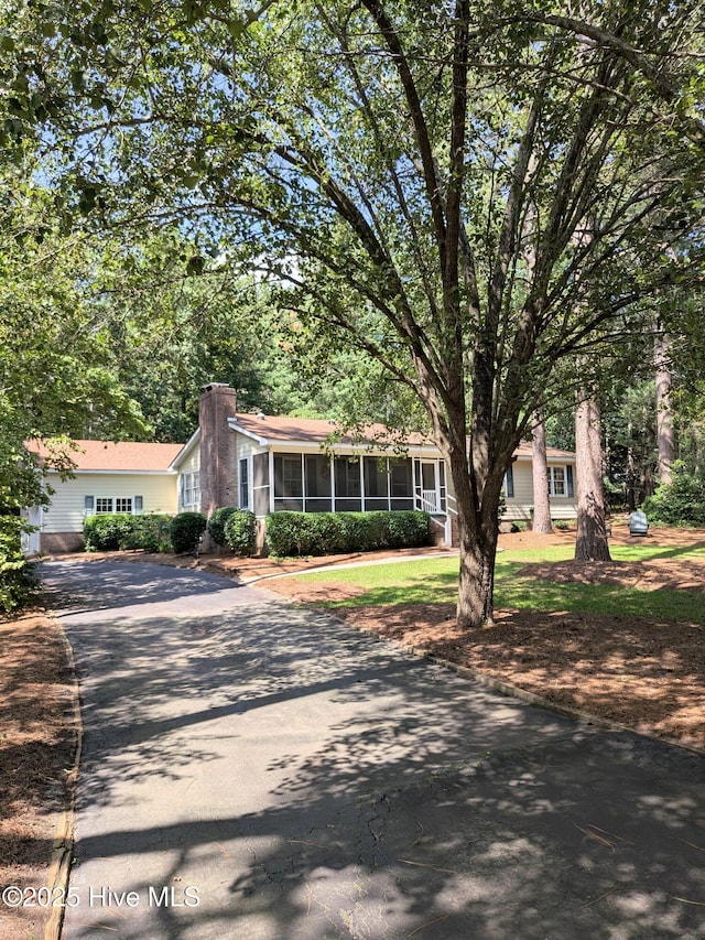 106 Brown Bark Rd, West End, NC 27376 - ranch-style home with a sunroom, driveway, and a chimney