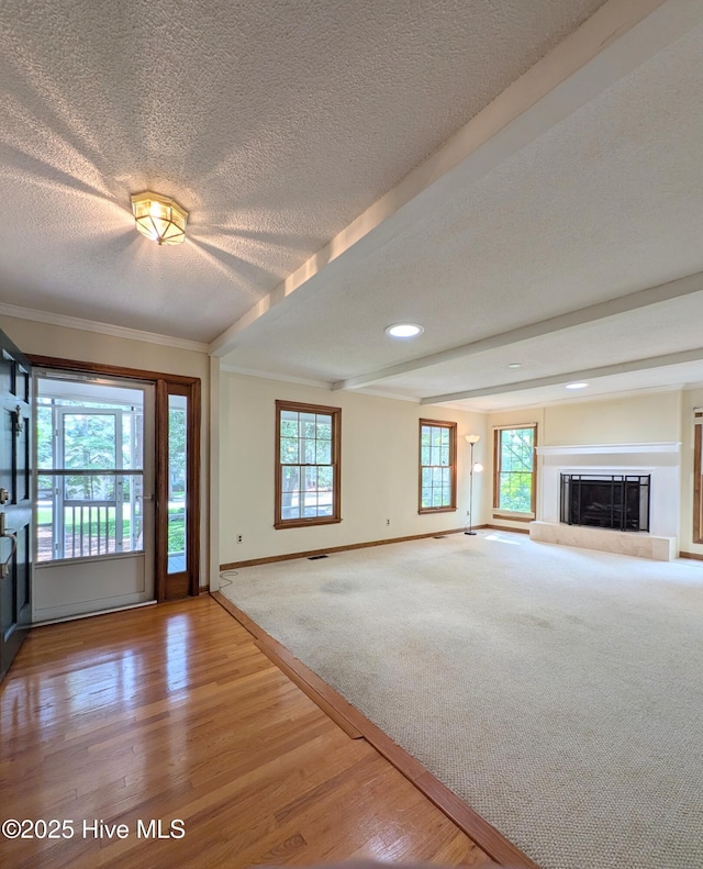 106 Brown Bark Rd, West End, NC 27376 - unfurnished living room with a textured ceiling, wood finished floors, crown molding, a glass covered fireplace, and recessed lighting