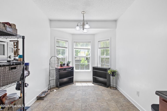 110 Whiteleaf Dr, Jacksonville, NC 28546 - entrance foyer with a chandelier, a textured ceiling, and stone finish floors