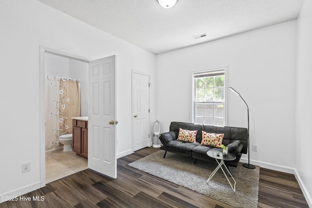 110 Whiteleaf Dr, Jacksonville, NC 28546 - living area with dark wood finished floors and a textured ceiling