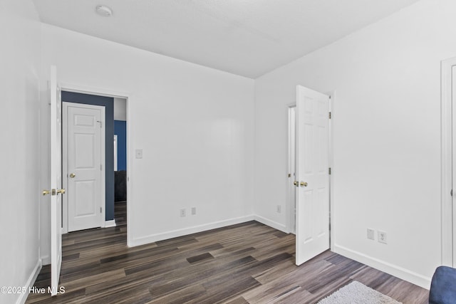 110 Whiteleaf Dr, Jacksonville, NC 28546 - unfurnished bedroom with dark wood-style floors and baseboards