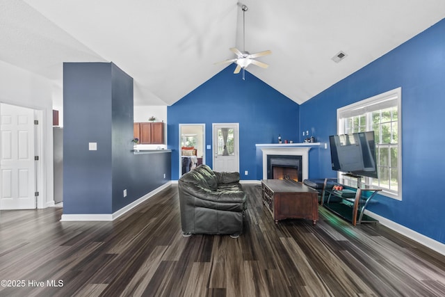 110 Whiteleaf Dr, Jacksonville, NC 28546 - living area with dark wood-style flooring, a ceiling fan, a warm lit fireplace, and lofted ceiling