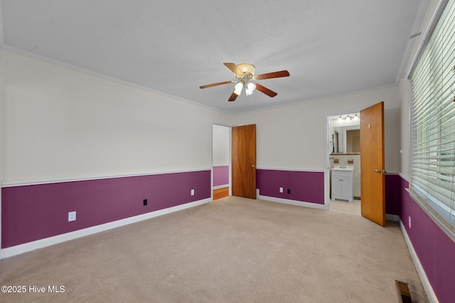1603 Laurel St, Goldsboro, NC 27530 - unfurnished bedroom with light carpet, crown molding, connected bathroom, and ceiling fan