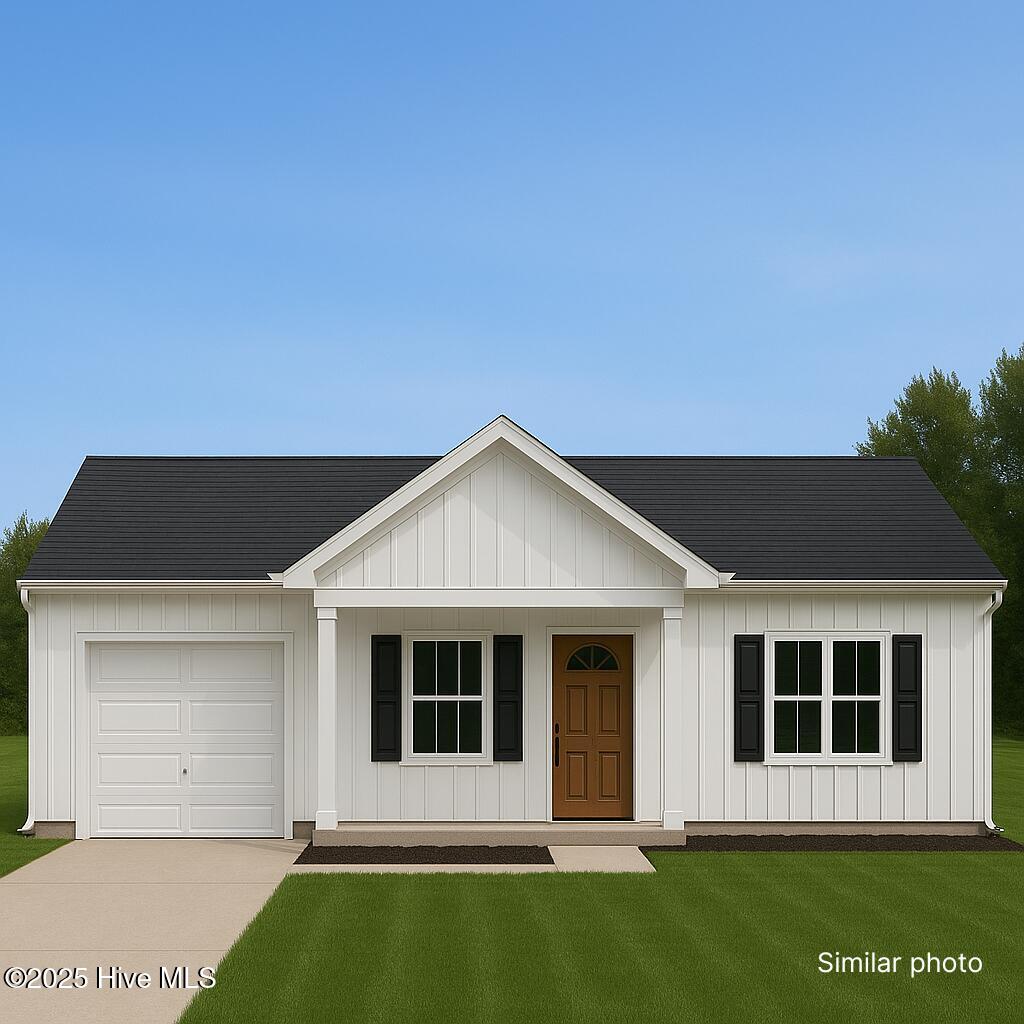 5650 County Line Rd, New Bern, NC 28562 - modern farmhouse featuring a garage, board and batten siding, a front lawn, a porch, and concrete driveway