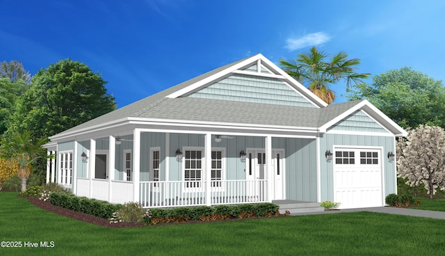 163 NW 4th St, Oak Island, NC 28465 - view of front of property featuring a garage, covered porch, a front lawn, and roof with shingles