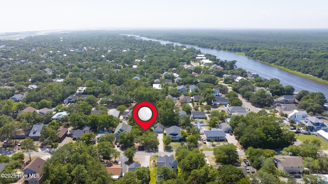 163 NW 4th St, Oak Island, NC 28465 - aerial view of residential area with a large body of water and a forest
