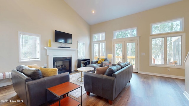 5410 Trade Winds Rd, New Bern, NC 28560 - living area with high vaulted ceiling, healthy amount of natural light, wood finished floors, and a fireplace