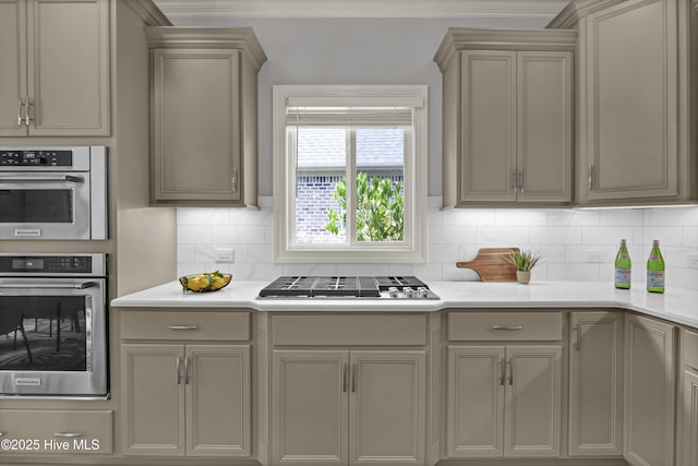 2233 Whiskey Branch Dr, Wilmington, NC 28409 - kitchen with stainless steel appliances, backsplash, light countertops, and gray cabinetry