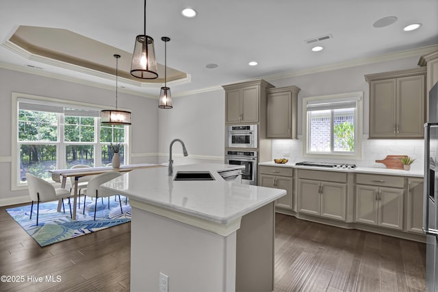2233 Whiskey Branch Dr, Wilmington, NC 28409 - kitchen with appliances with stainless steel finishes, gray cabinetry, crown molding, dark wood-style floors, and tasteful backsplash
